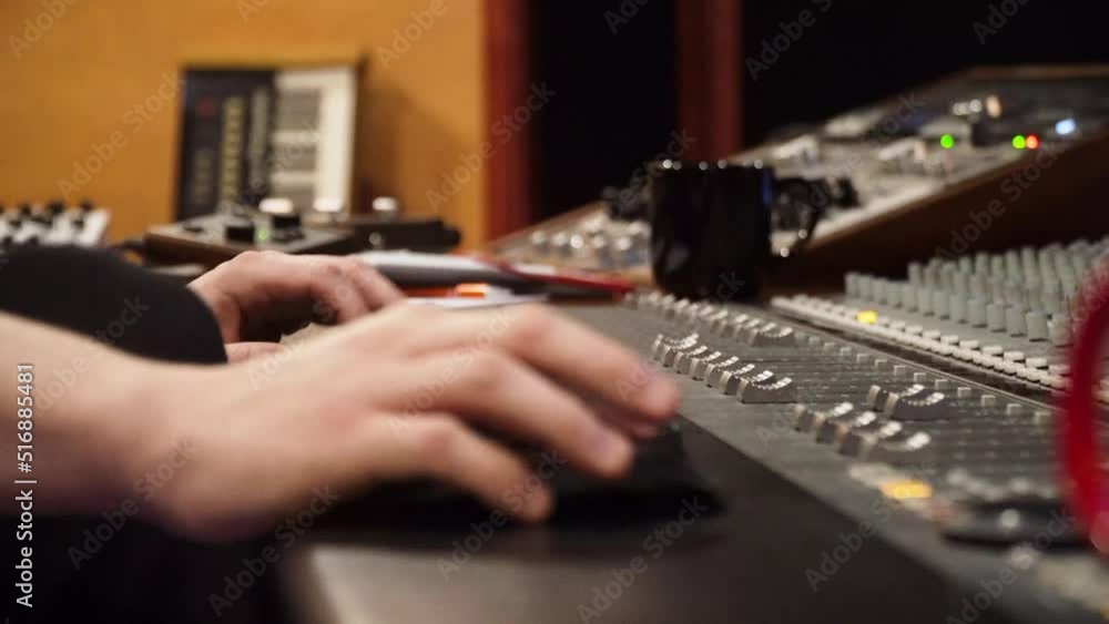 Poster man working in the music recording studio with console. - close up