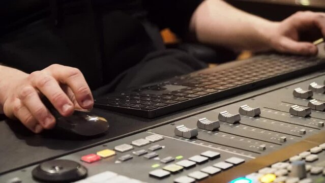 Man Working In The Studio Using Music Console, Desktop Mouse And Keyboard. - close up
