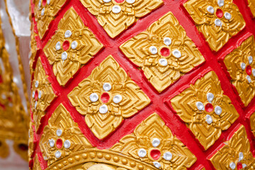 Stucco designs in Thai art are popularly adorned on the statue in the trousers section.