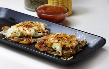Mini Pizza or homemade baked potato pizza served with onion,tomato,corn,capsicum,cheese and mayonnise.
