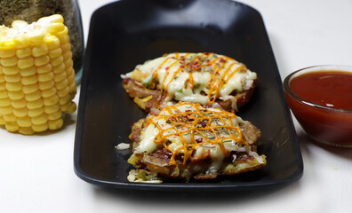 Mini Pizza or homemade baked potato pizza served with onion,tomato,corn,capsicum,cheese and mayonnise.