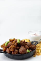 Delicious  crispy and crunchy Indian deepfried snacks Dal vada or dal pakoda or moong dal vade or pakora or fritters with green chilly and chutney or curd.