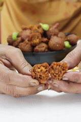 Delicious  crispy and crunchy Indian deepfried snacks Dal vada or dal pakoda or moong dal vade or pakora or fritters with green chilly and chutney or curd.