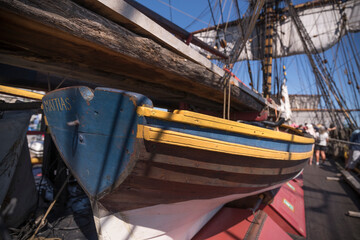 The old row boat named Mattias on the replica of the old Indian Man Götheborg, at a pier old town...