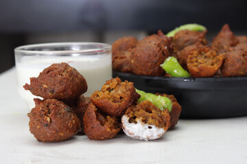 Delicious  crispy and crunchy Indian deepfried snacks Dal vada or dal pakoda or moong dal vade or pakora or fritters with green chilly and chutney or curd.