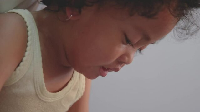 little asian baby girl with curly hair tantrum, crying loudly. slow motion video