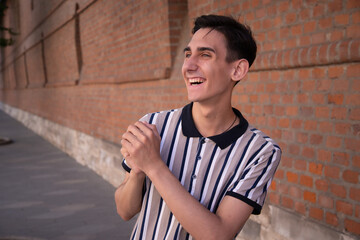 Education and entertainment. A young attractive student walks down the street.