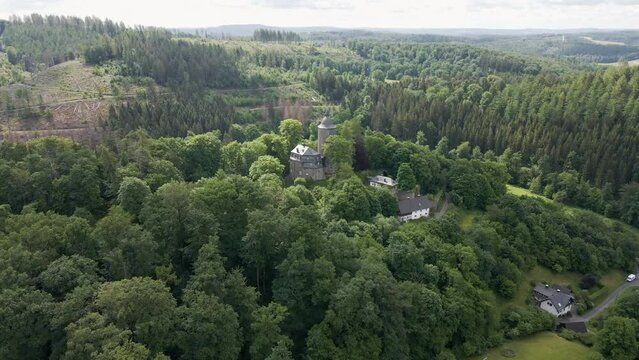 rearward drone shot of Wildenburg Castle in the southeast of the village of Friesenhagen in the North Rhine-Westphalia region of Germany.