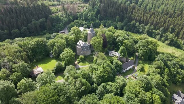 down tilting drone footage of the wildenburg castle  in the southeast of the village of Friesenhagen  in the North Rhine-Westphalia region of Germany.