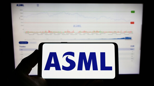 Stuttgart, Germany - 07-10-2022: Person holding mobile phone with logo of Dutch semiconductor company ASML Holding N.V. on screen in front of web page. Focus on phone display.