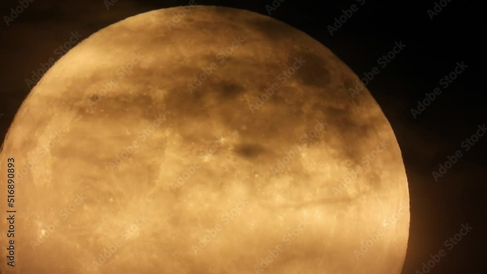 Wall mural timelapse of a full moon being gradually covered by dark clouds on the sky