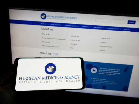 Stuttgart, Germany - 07-10-2022: Person holding smartphone with logo of EU agency European Medicines Agency (EMA) on screen in front of website. Focus on phone display.