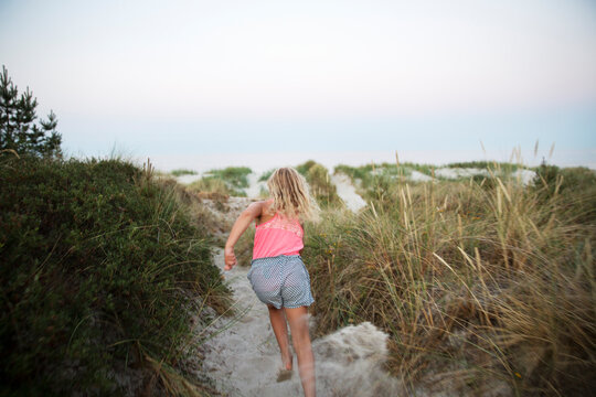 Girl running on sand beach