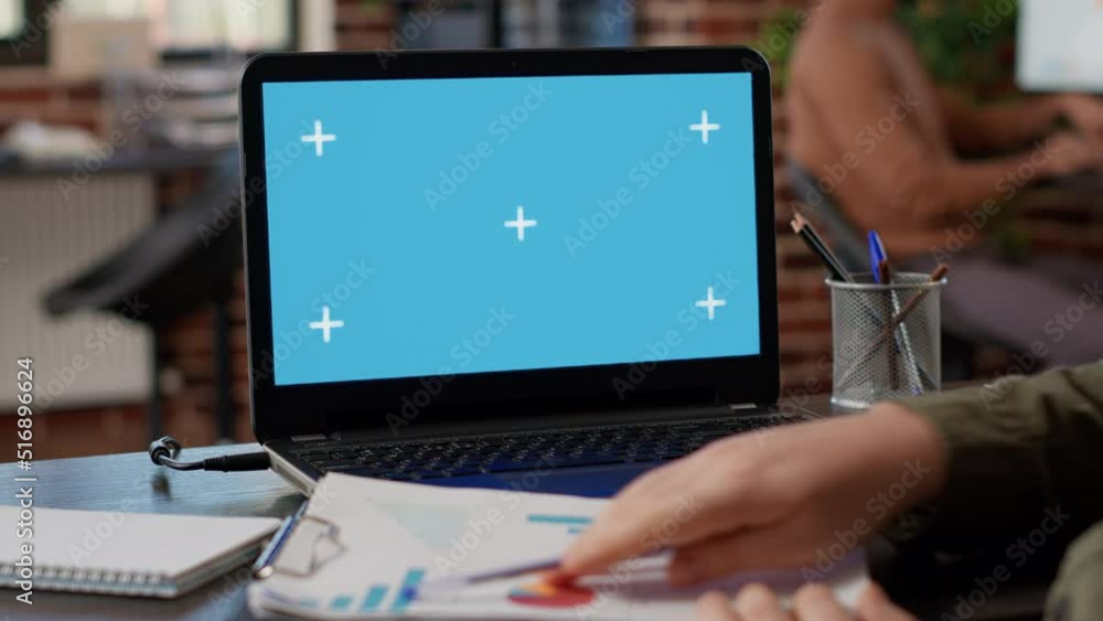 Poster male freelancer analyzing business charts and greenscreen on laptop, using blank chroma key display 