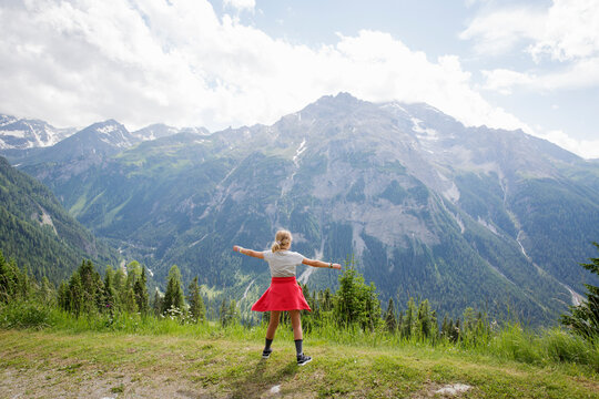 Girl standing by mountain in Switzerland