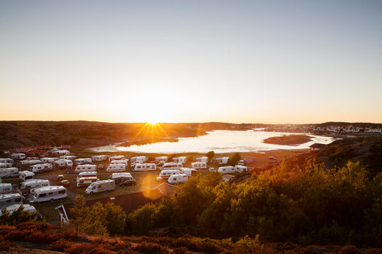 Campervans at camping ground during sunset