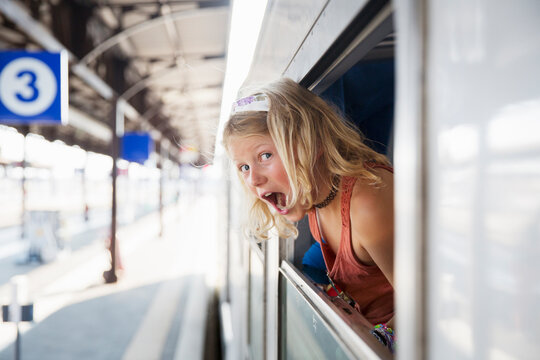 Girl in window of train