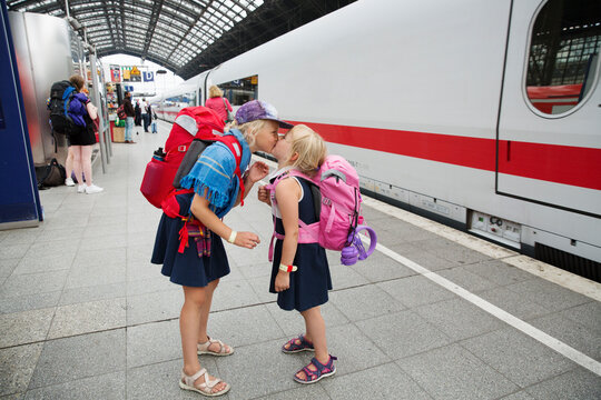 Sisters kissing at train station