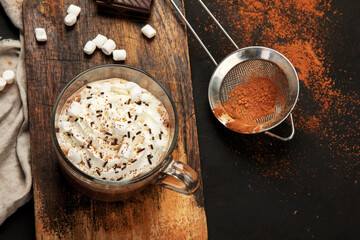 Cacao with marshmallow and cacao powder in mug.
