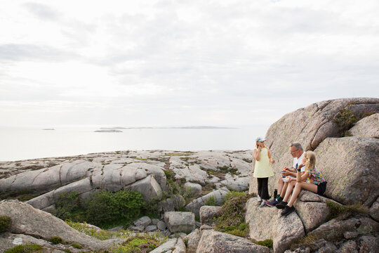 Family on rocks by sea
