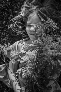 Girl holding bouquet of Queen Anne's Lace flowers