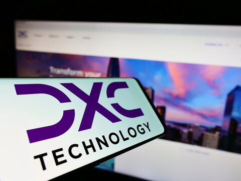 Stuttgart, Germany - 07-10-2022: Cellphone with logo of US IT consulting firm DXC Technology Company on screen in front of business website. Focus on center of phone display.