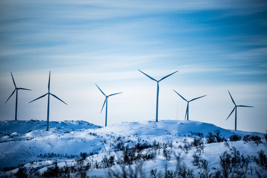 Wind turbine on snowy hills