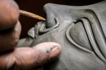 Creating clay head of goddess Durga in Kumartuli, Kolkata, India. The idols are made for the Hindu...