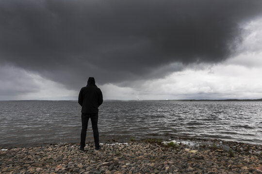 Man standing on shore of Lake Glan Sweden