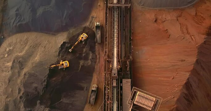 Excavators Loading Dump Trucks With Coal From Stockpile At Paradip Port In India. - aerial overhead