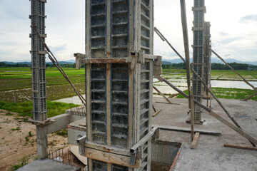 Concrete column formwork made of plastic reinforced with the steel core on construction site.