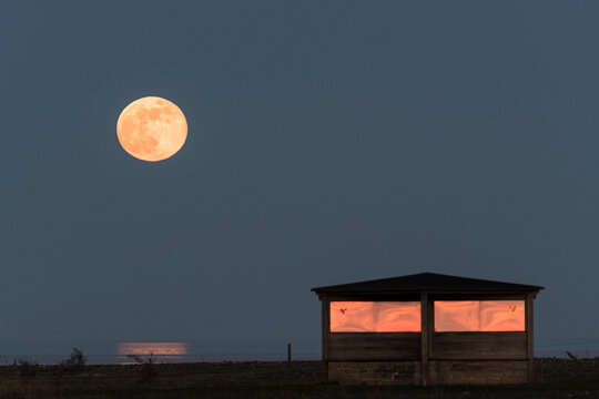 Cabin under full moon at sea