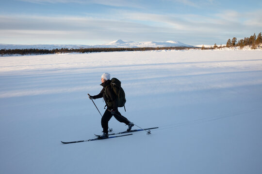 Woman cross-country skiing on Lake Grovelsjon in Rogen Nature Reserve Sweden