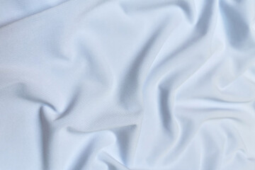 Blue crepe satin crumpled or wavy fabric texture background. Abstract linen cloth soft waves. Silk fabric. Smooth elegant luxury cloth texture. Concept for banner or advertisement.