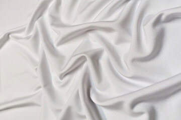 White supplex crumpled or wavy fabric texture background. Abstract linen cloth soft waves. Silk fabric. Smooth elegant luxury cloth texture. Concept for banner or advertisement.