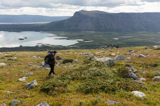 Young woman hiking in Rapa Valley in Sarek National Park Sweden