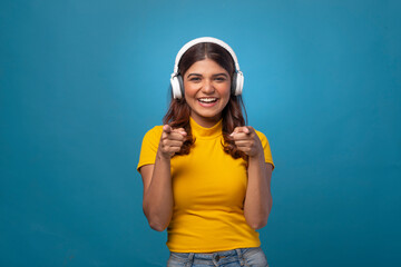 Beautiful happy young woman with headphones, coffee, phone , tablet, red cap 