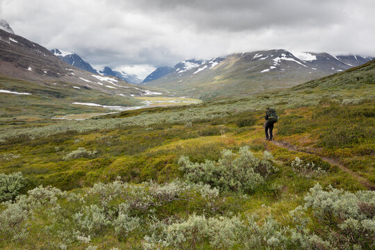 Young woman hiking in Rapa Valley in Sweden