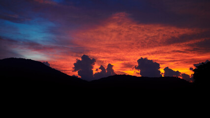 Sunset art print blue twilight clouds orange glowing light. Sunset background concept.