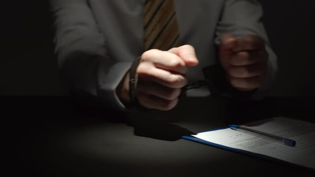 Businessman Wearing Formal Clothing Signs A Document With Hands Handcuffed
