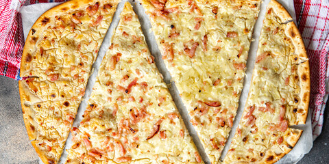 Flammkuchen savory pie bacon, onion, sour cream pastrie pie fresh meal food snack on the table copy...