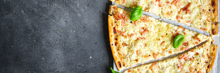 Flammkuchen savory pie bacon, onion, sour cream pastrie pie fresh meal food snack on the table copy...