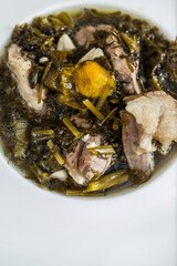 Soup with parsley, meat, lemon, spinach