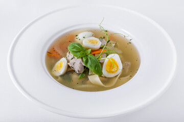 Soup with boiled egg, basil, green pea sprouts, meat and noodles