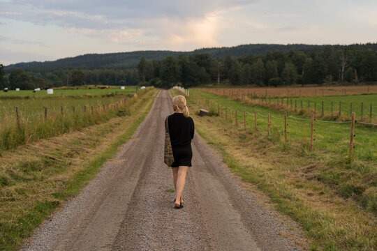 Woman walking on rural road