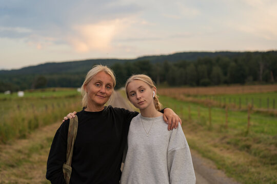 Portrait of mother and daughter on rural road