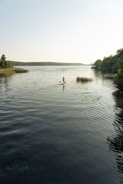 Young man paddleboarding on lake