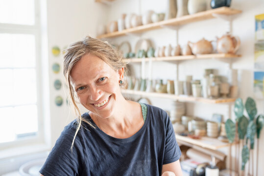 Portrait of smiling potter in workshop