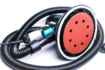 Rotary grinder with a black corrugated hose to connect to a vacuum cleaner, isolate on a white background