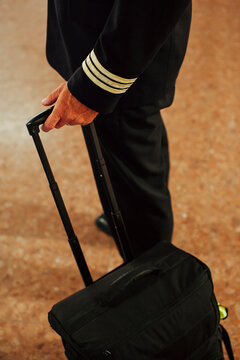 Pilot walking with luggage in airport